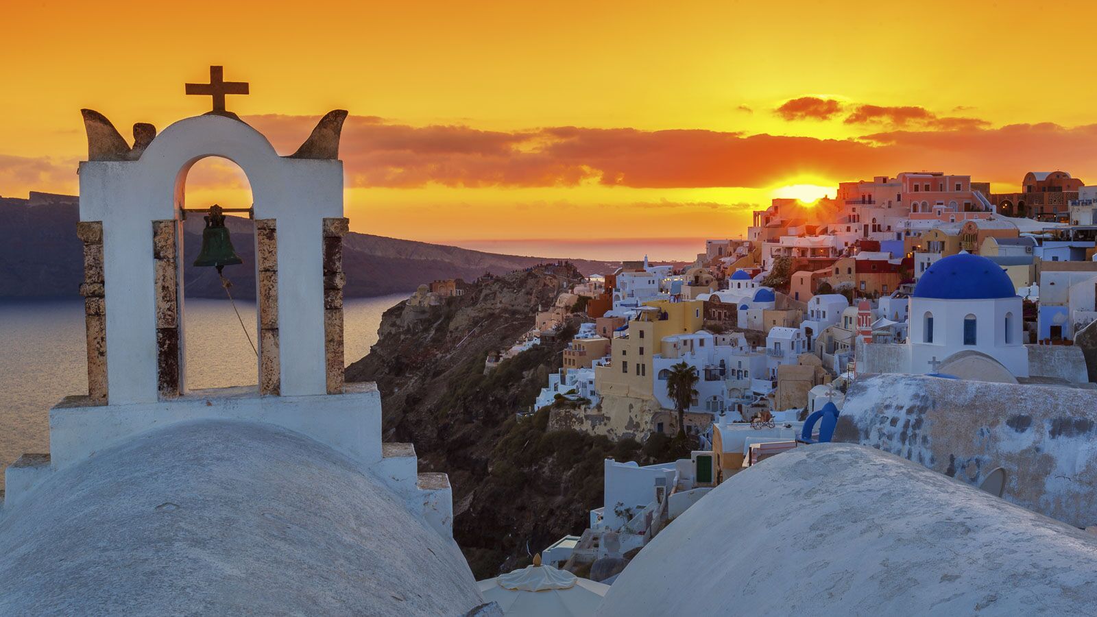 santorini blue domes and bells at sunset